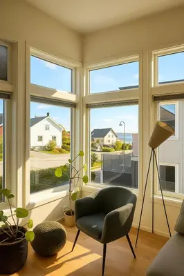 a living room with large windows and a chair at Panoramic View & Comfort in Ålesund