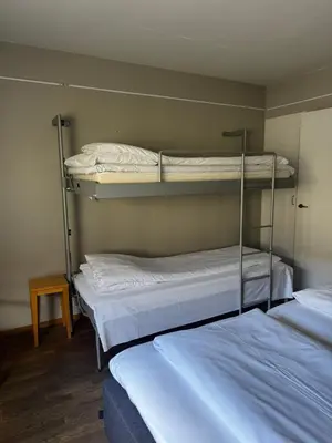 a room with two bunk beds and a table at Dølaheimen in Lillehammer