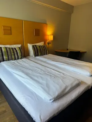 a large white bed in a hotel room at Dølaheimen in Lillehammer