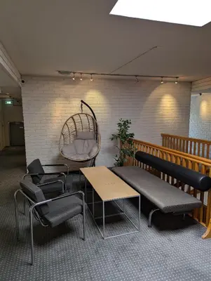 a room with chairs and a bench and a table at Dølaheimen in Lillehammer