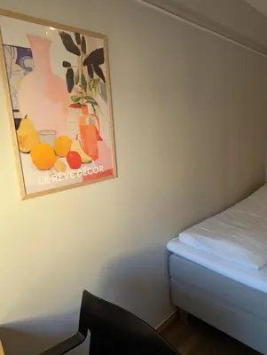 a bedroom with a picture of fruit on the wall at Dølaheimen in Lillehammer