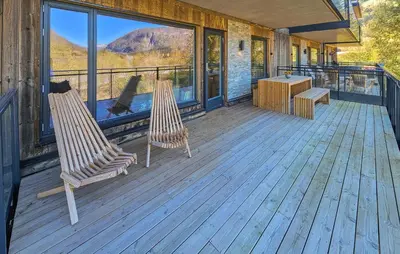 two chairs sitting on a deck with a view at Stunning Apartment In Hemsedal in Hemsedal