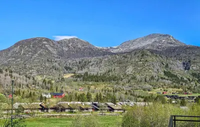 a mountain with a village and houses in front of it at Stunning Apartment In Hemsedal in Hemsedal