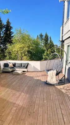 a bench sitting on top of a patio at 2BR, 2 parking spots, EV-charger and home office in Trondheim