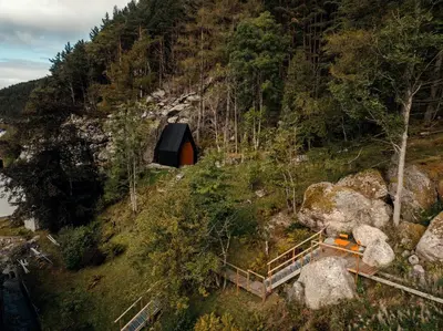 an aerial view of a cabin on the side of a mountain at Spectacular Fjord getaway - The Forge in Leirgulen