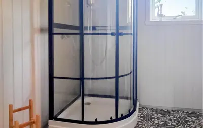 a glass shower with blue stripes on a room at Awesome Home In Sævareid With Lake View in Sævareid