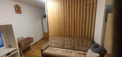 a living room with a couch and a television at Stodio in Lii