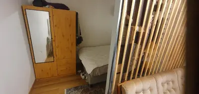 a bedroom with a mirror and a small bed at Stodio in Lii