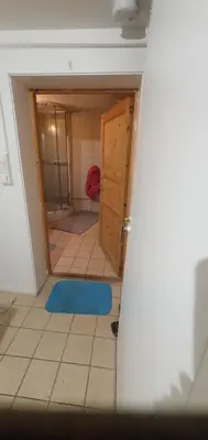 a bathroom with a door and a blue rug at Stodio in Lii