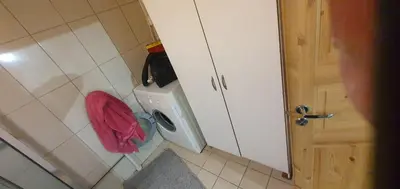 a bathroom with a washing machine with a red towel at Stodio in Lii