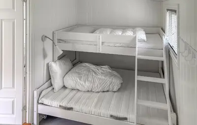 a room with two bunk beds in a room at 1 Bedroom Awesome Home In Vik I Sogn in Vikøyri