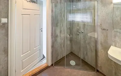 a bathroom with a shower with a glass door at 1 Bedroom Awesome Home In Vik I Sogn in Vikøyri