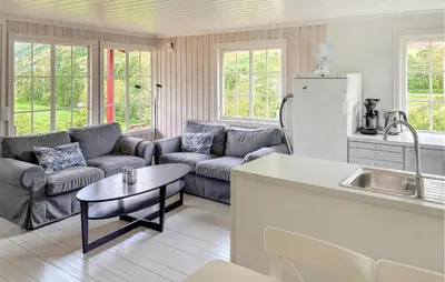 a kitchen and living room with a couch and a refrigerator at 1 Bedroom Awesome Home In Vik I Sogn in Vikøyri