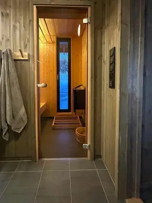 a bathroom with a toilet and a door to a room at Modern Cabin By The Ski Trails At Fagerhøy in Sør-Fron