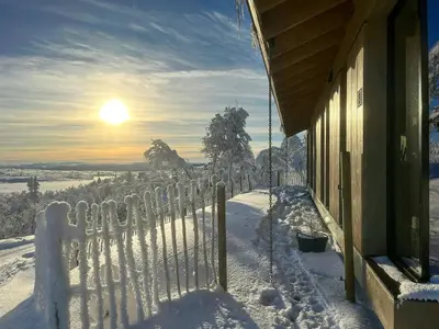 a fence covered in snow next to a building at Modern Cabin By The Ski Trails At Fagerhøy in Sør-Fron