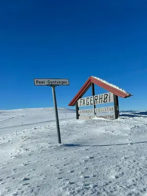 a sign in the snow in front of a store at Modern Cabin By The Ski Trails At Fagerhøy in Sør-Fron