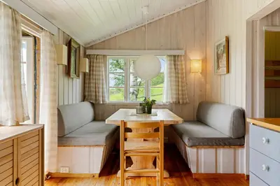 a tiny house with benches and a table in a kitchen at Mountain Base For Active Explorers in Oppdal