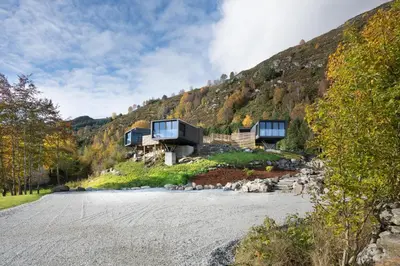 a house on the side of a mountain at Torvika Seaview Pods in Bølandet