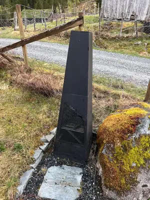 a black object sitting on the side of a road at Cozy chair in Jølster in Skei