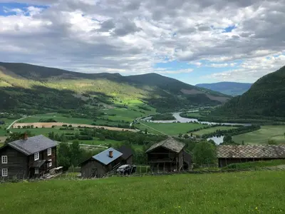 a view of a valley with houses and a river at Farm In The Heart Of Gudbrandsdalen in Kvam