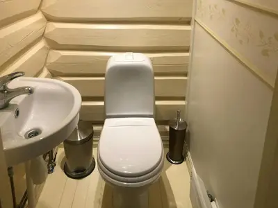 a small bathroom with a toilet and a sink at Farm In The Heart Of Gudbrandsdalen in Kvam