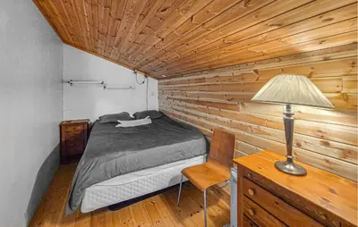 a bedroom with a bed and a desk and a lamp at Nice Apartment In Bergen With Wifi in Bergen