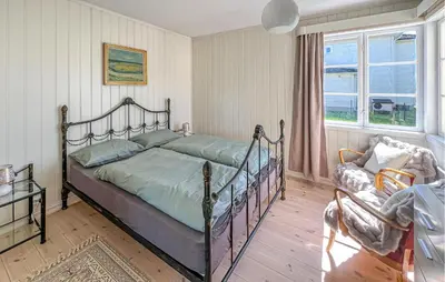 a bedroom with a metal bed and a window at Lovely Apartment In Lillehammer in Lillehammer