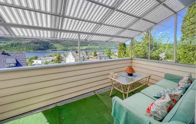 a screened in porch with a table and chairs at 2 Bedroom Nice Apartment In Lillehammer in Lillehammer
