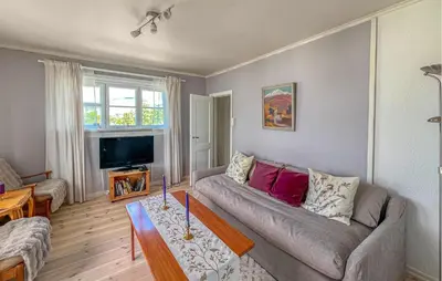 a living room with a couch and a table at 2 Bedroom Nice Apartment In Lillehammer in Lillehammer