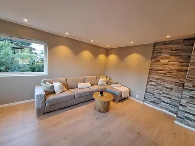 a living room with a couch and a table at Modern house in Bergen