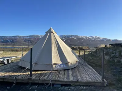 a tent sitting on a wooden deck at Syndinstøga in Ryfoss
