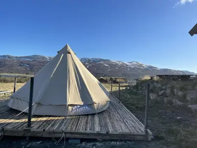 a tent sitting on a wooden deck at Syndinstøga in Ryfoss