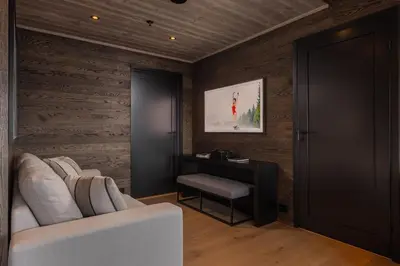 a living room with a white couch and a table at New and exclusive chalet apartment with mountain panorama view in Tuv