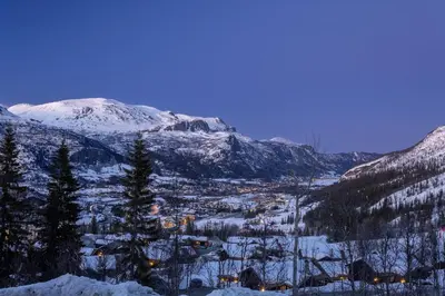 a snow covered valley with a town and mountains at New and exclusive chalet apartment with mountain panorama view in Tuv