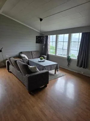 a living room with a couch and a table at Hardanger Fjord Living in Vossevangen