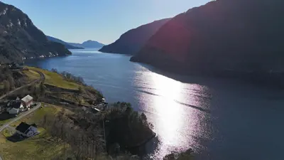 an aerial view of a large river with mountains at Hardanger Fjord Living in Vossevangen