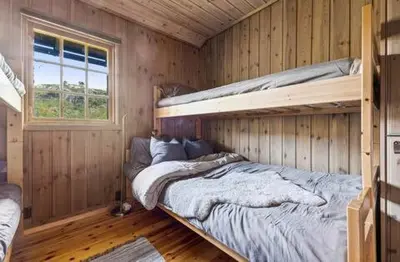 a bedroom with two bunk beds in a cabin at Guest favorite - 5 mins from Vøringsfossen in Garden