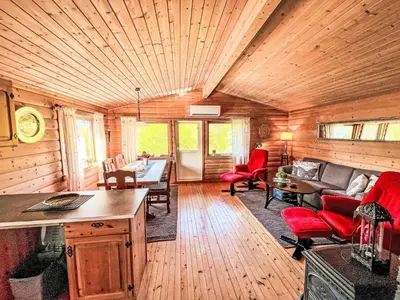 a living room with red chairs and a wooden ceiling at Holiday Home Tussebu by Interhome in Gripne