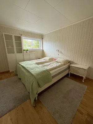 a bedroom with a large bed and a window at Stryn Central View in Stryn