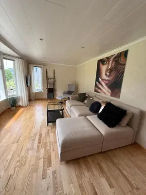 a living room with a couch and a painting on the wall at Stryn Central View in Stryn