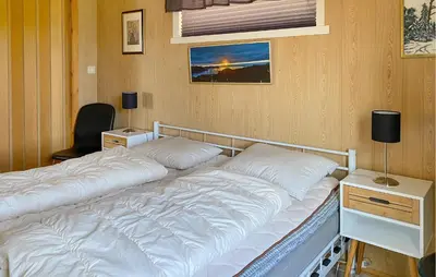 a bed with two pillows on it in a room at Stunning Apartment In Selje With Wifi in Selje