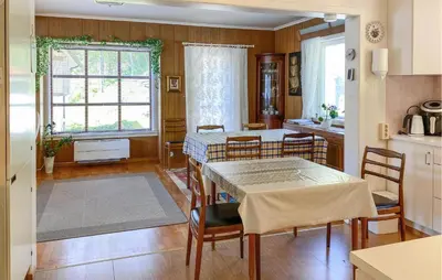a kitchen and dining room with a table and chairs at Stunning Apartment In Selje With Wifi in Selje