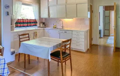 a kitchen with a table and chairs and a sink at Stunning Apartment In Selje With Wifi in Selje