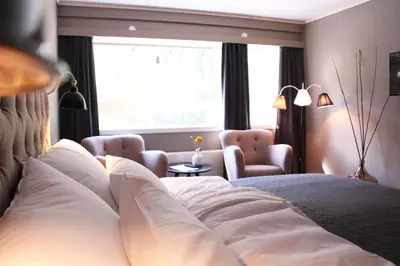 a hotel room with a bed and a window at Haukeli Hotel in Haukeligrend