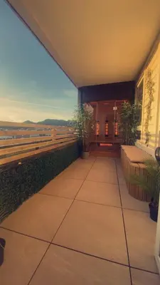 a balcony with benches and a view of the ocean at Penthouse apartment with sauna, balcony and free coffe in Bergen