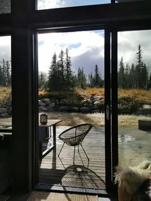 a glass door of a patio with a table and a chair at Family Cabin With Annexe In Haglebu in Eggedal