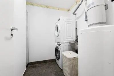 a laundry room with a washing machine and a washer at Bønes in Bergen