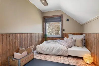 a bedroom with a bed and a window at Kvitsand Ocean Castle in Hitra