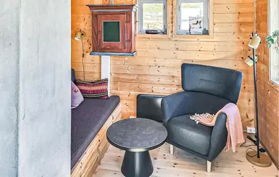 a room with a couch and a chair and a table at Lovely Home In Vøringsfoss With Sauna in Maurset