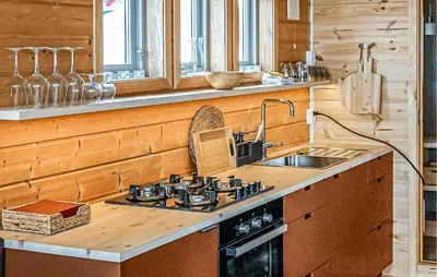 a kitchen with a stove and a sink at Lovely Home In Vøringsfoss With Sauna in Maurset